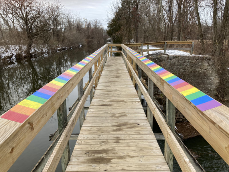 the wheatpasted rainbows by Lambertville artist Gwenn Seemel on the Alexauken Creek Spillway Bridge in the D&R Canal State Park