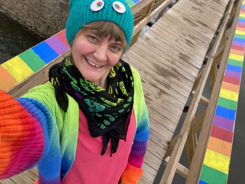 Lambertville artist Gwenn Seemel with the wheatpasted rainbows on the Alexauken Creek Spillway Bridge in the D&R Canal State Park