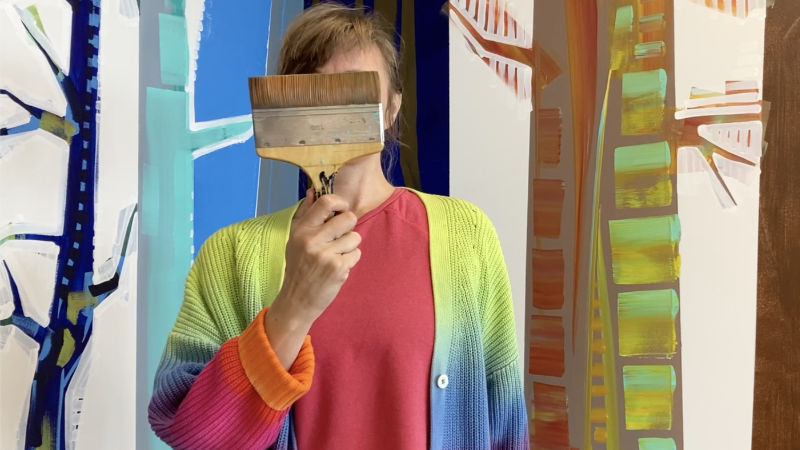 Gwenn Seemel at work on a mural 